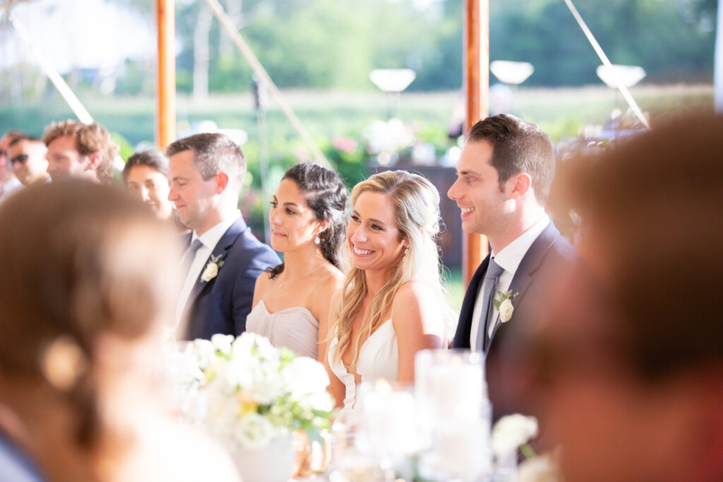 bride and groom laughing during wedding reception 