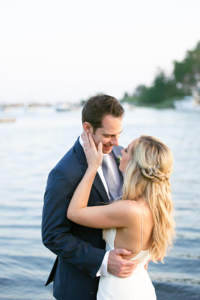 portrait of bride with her hand on the grooms face 