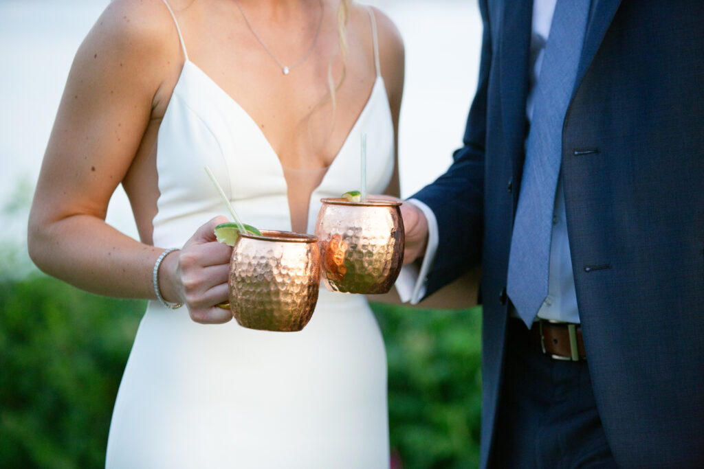 bride and groom holding copper cups