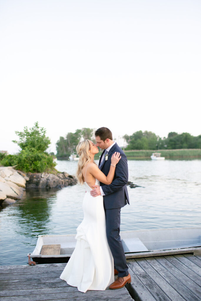 bride and groom looking at each other on the dock