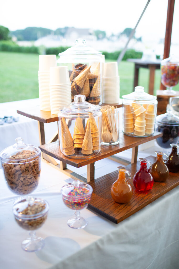 ice cream bar with ice cream cones and toppings 