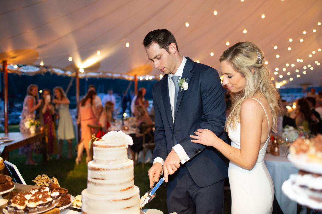 bride and groom cutting cake 