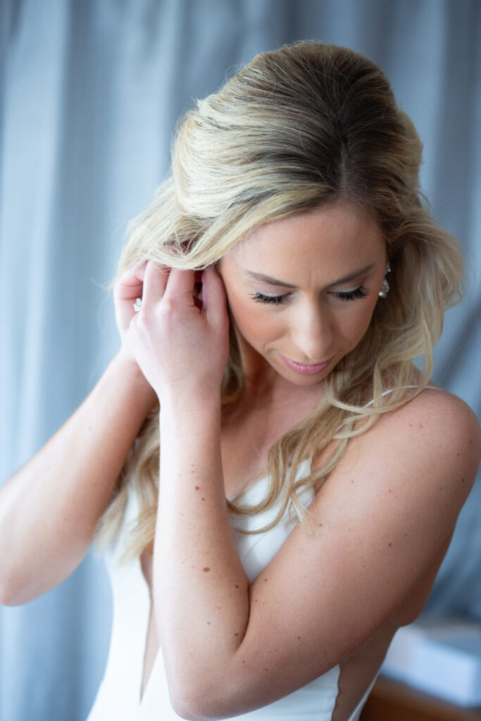 bride putting in earrings