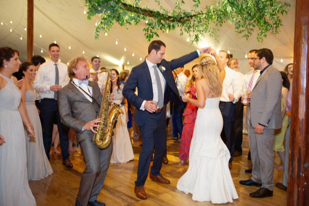 bride and groom dancing with their guests 