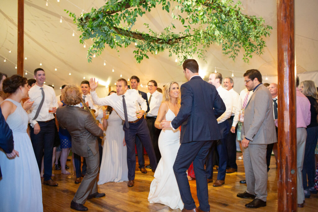 bride and groom dancing with their guests 