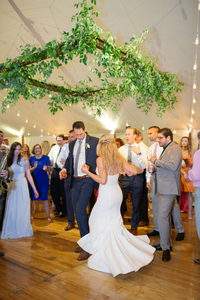 bride and groom dancing with their guests 