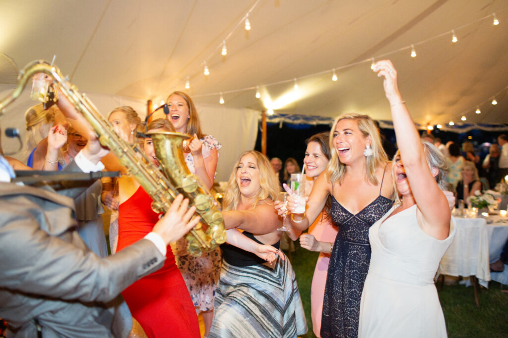 live saxophone player on the dance floor and guests dancing 