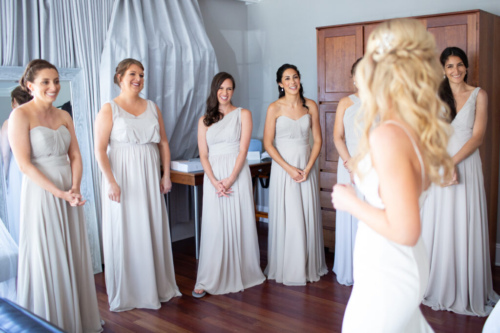 bridesmaids seeing bride in her dress for the first time