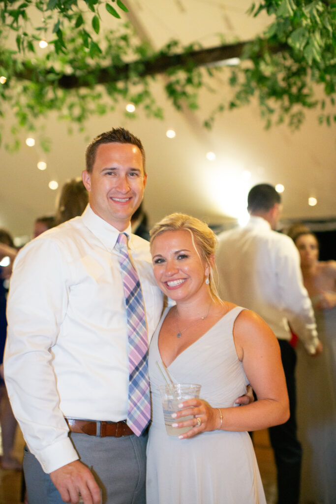 a couple at the wedding looking at camera 