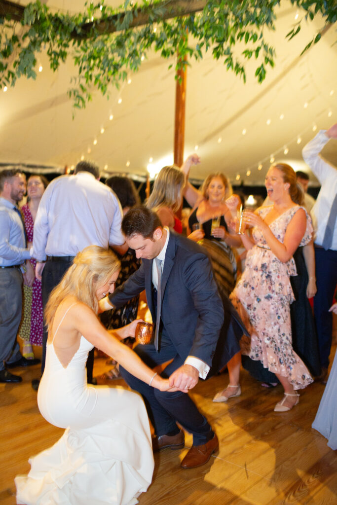 bride and groom dancing with their guests 