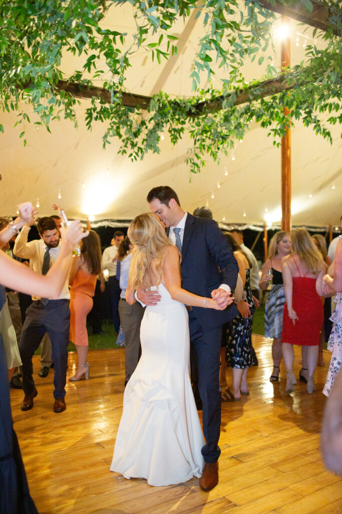 bride and groom dancing with guests around 