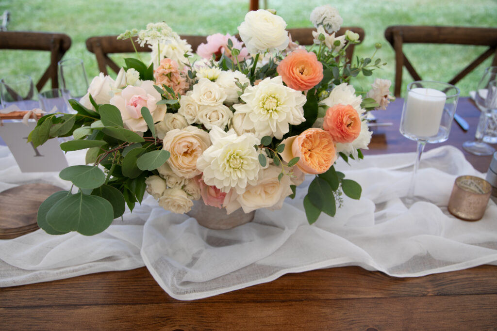 floral centerpieces with white dahlias and peach ranunculus flowers