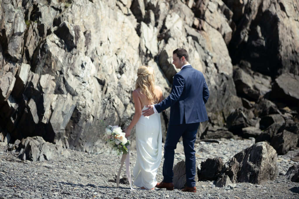 bride and groom on rocky beach