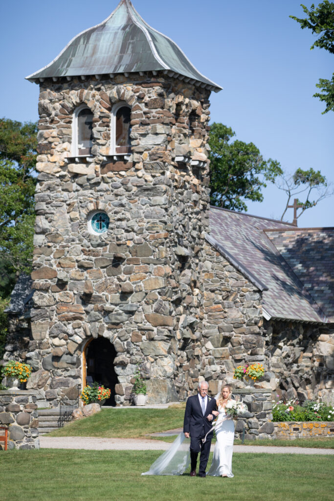 bride and her dad walking arm in arm