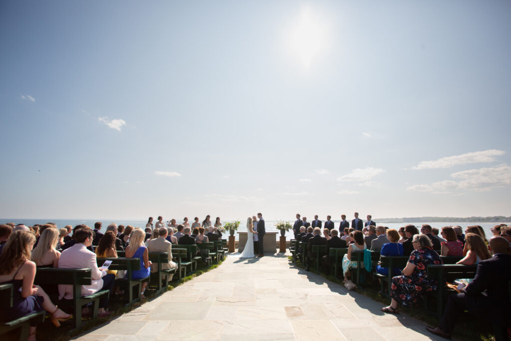 outside wedding ceremony location with the bride and groom at the front 