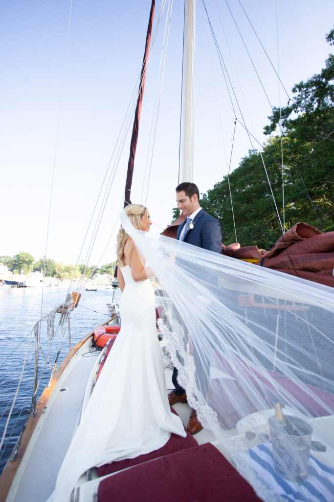 bride and groom on sailboat veil blowing in the wind