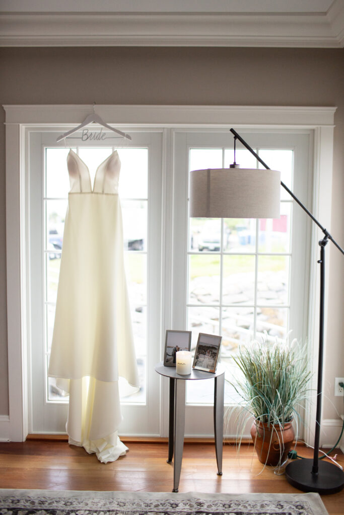 brides dress hanging in window 