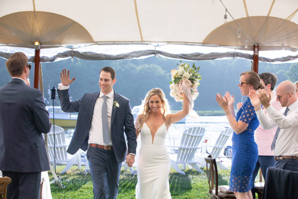 bride and groom cheering with arms up being introduced for the first time at the reception