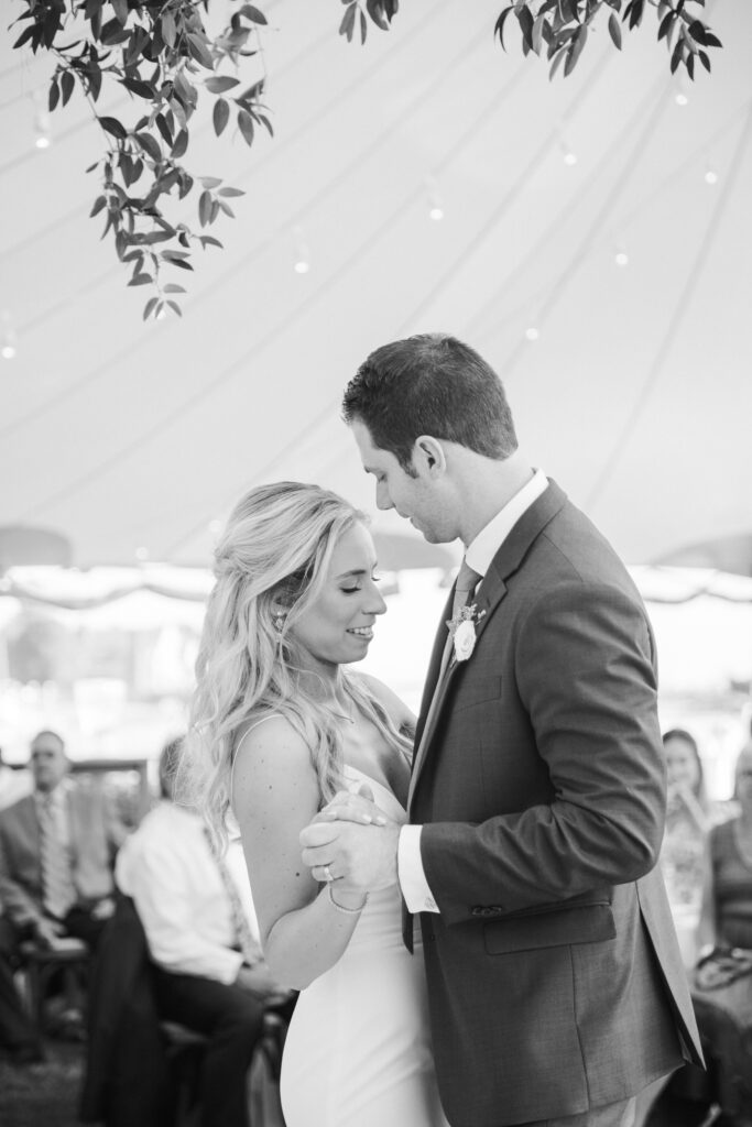 black and white of bride and groom dancing 