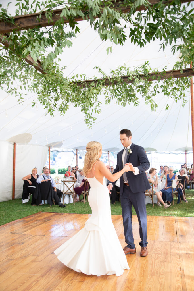 bride and groom dancing their first dance under the floral ceiling installation 