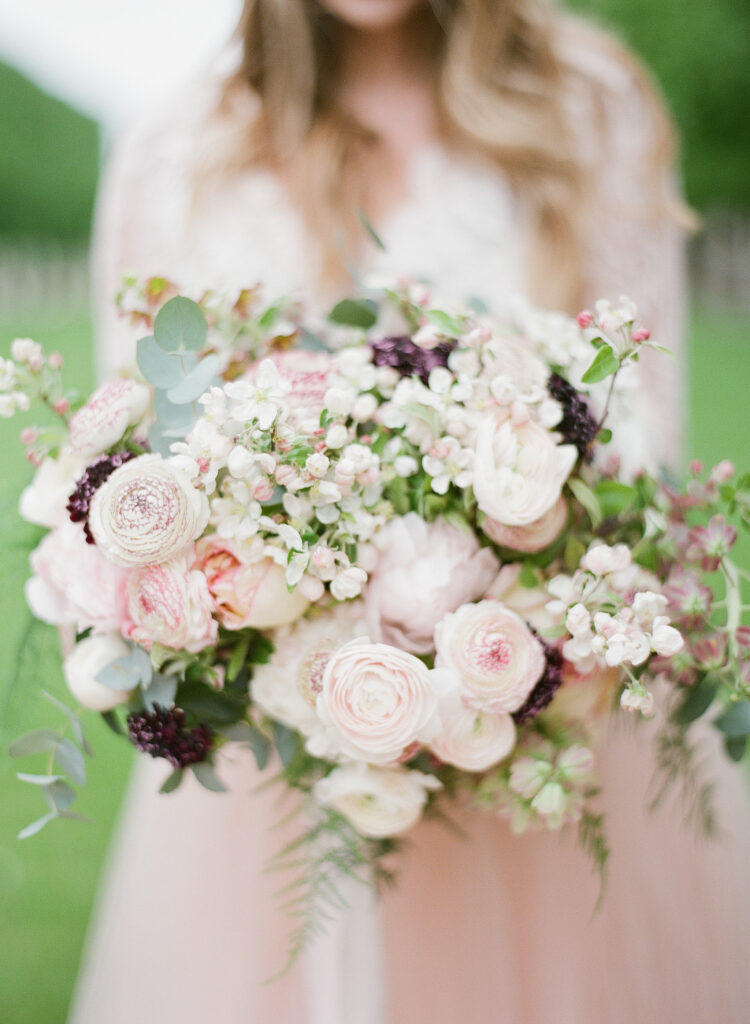 bouquet with pink and white peonies, anemones, and ranunculus flowers