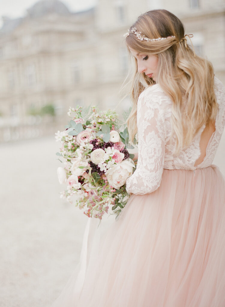 bride looking down at bouquet 