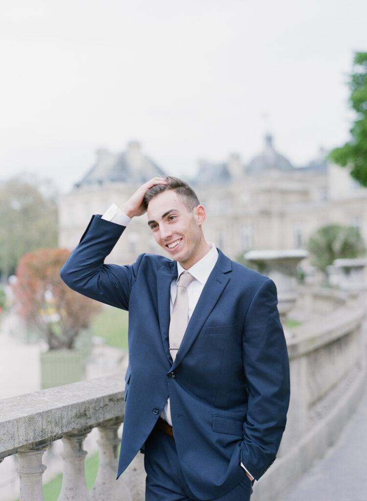 groom smiling with his hand casually in his hair 