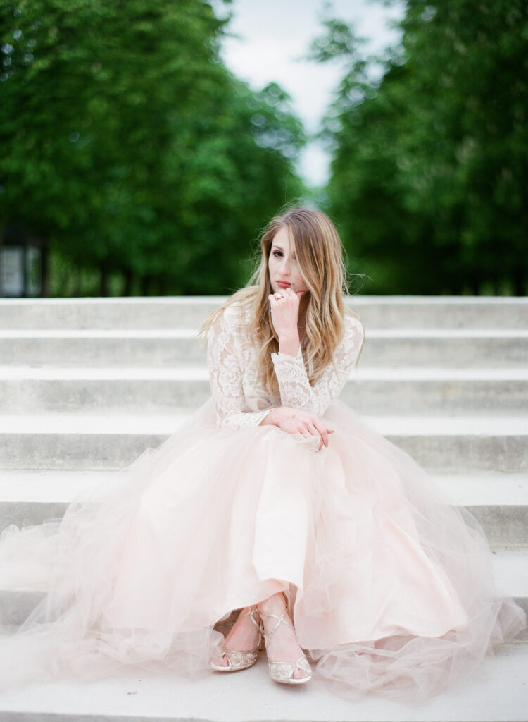 bride sitting with bella belle shoes showing