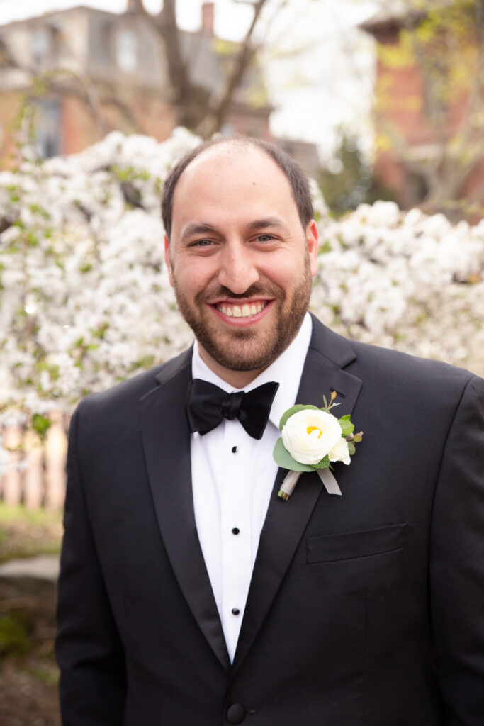 portrait of groom in black tie attire 