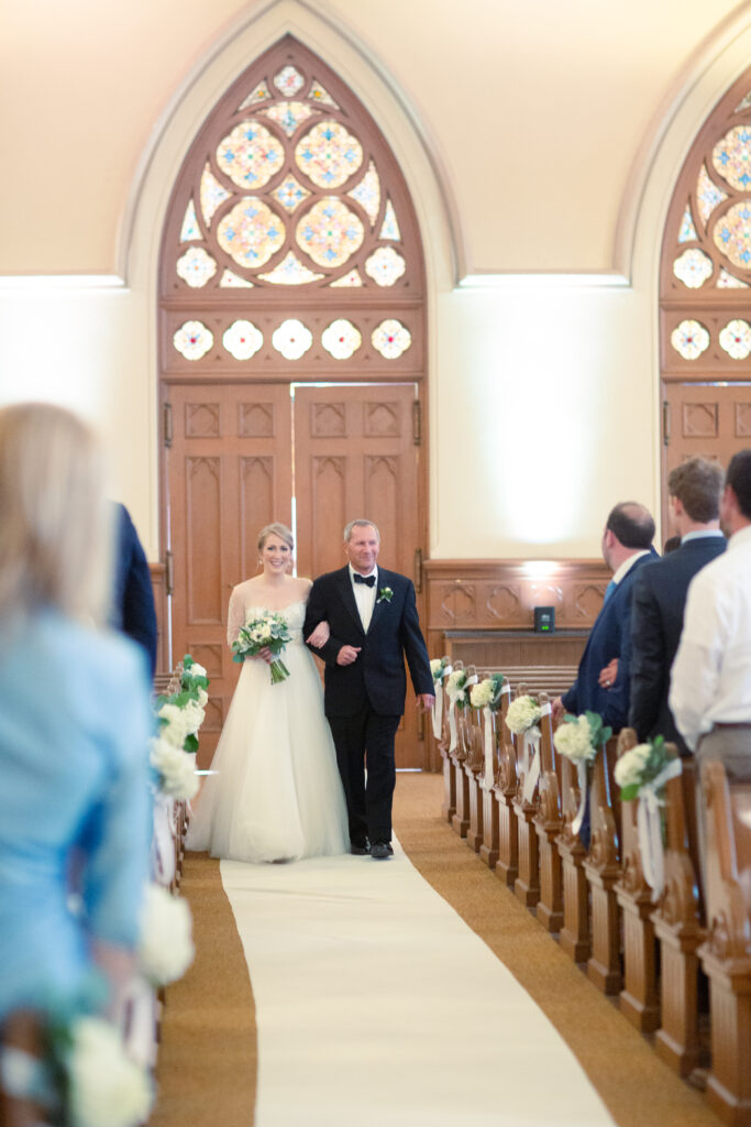 bride walking down the aisle with her dad