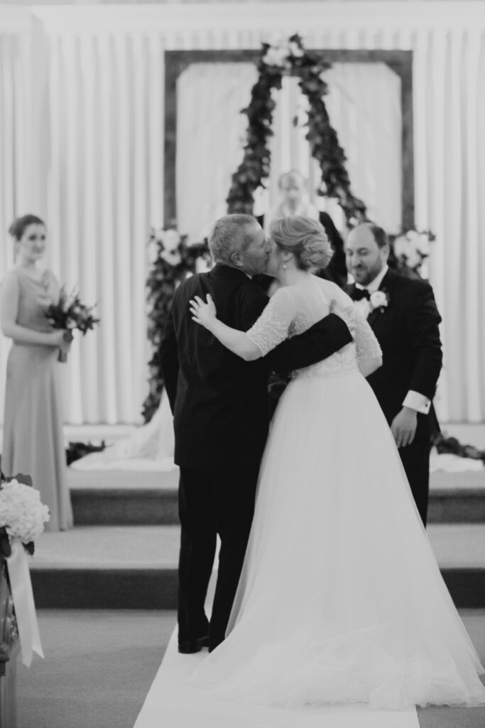 black and white of dad giving bride away 