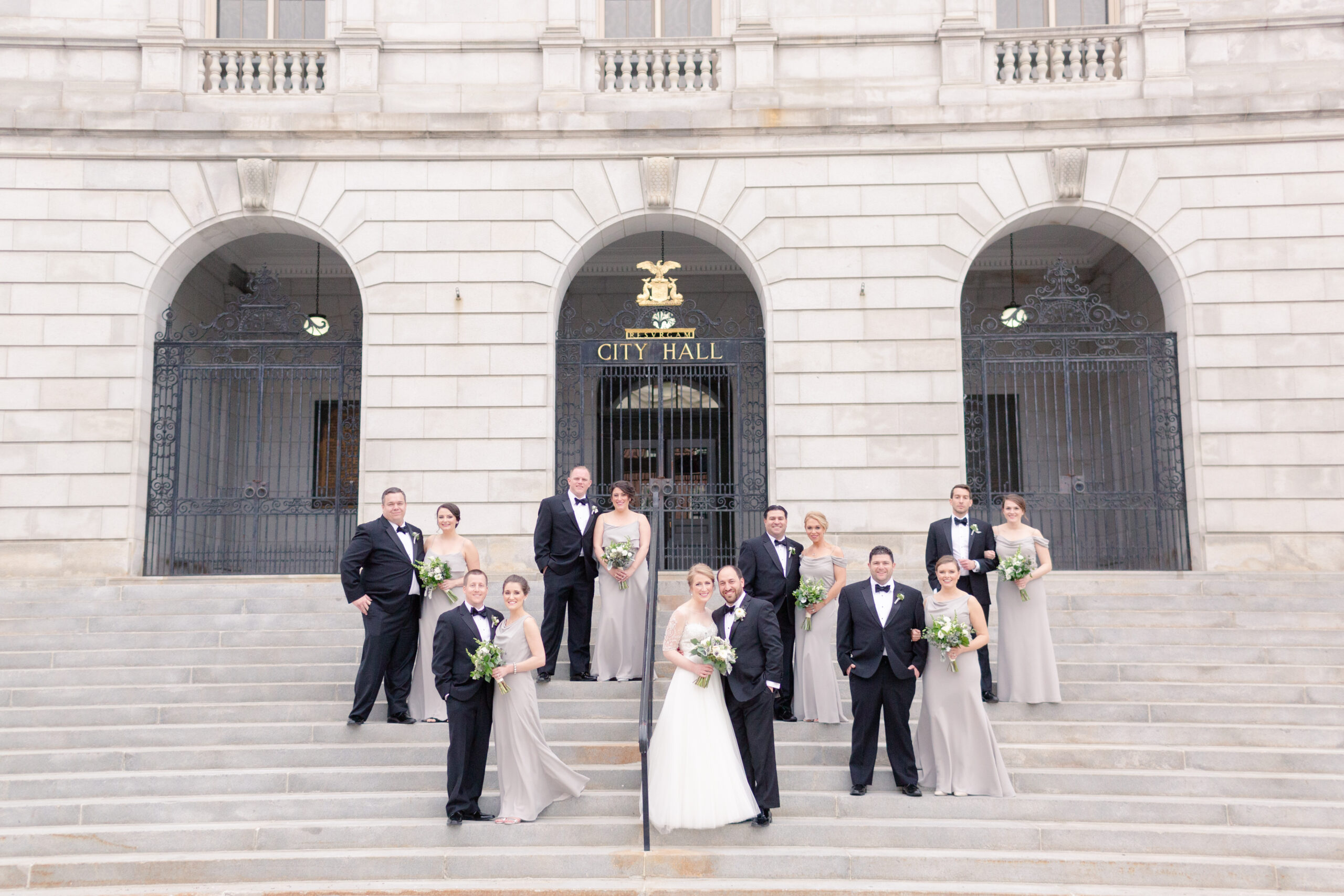 black tie wedding party on steps of city hall