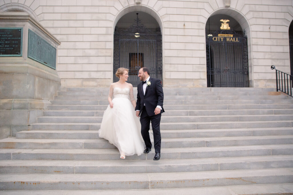 bride and groom holding hands