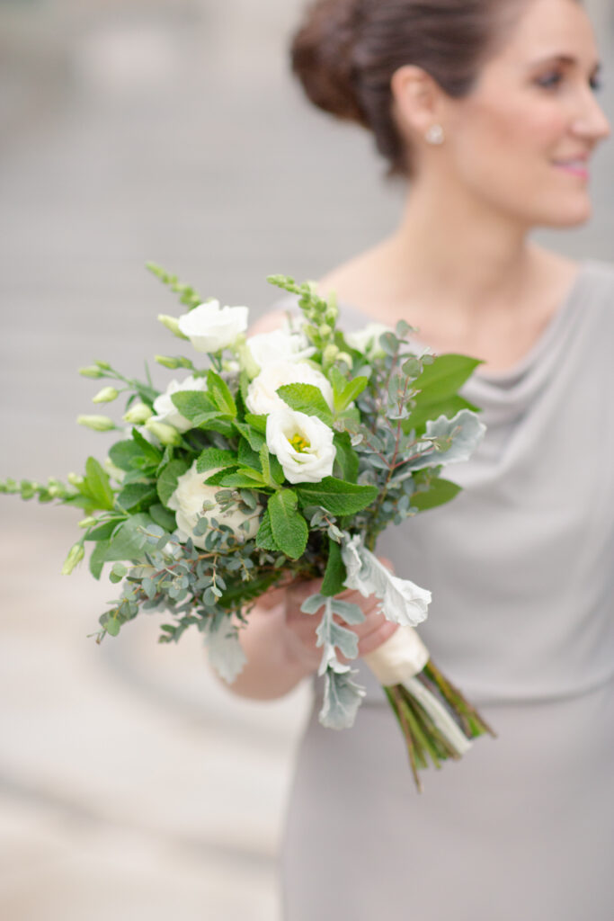 bridesmaid holding bouquet with white flowers 