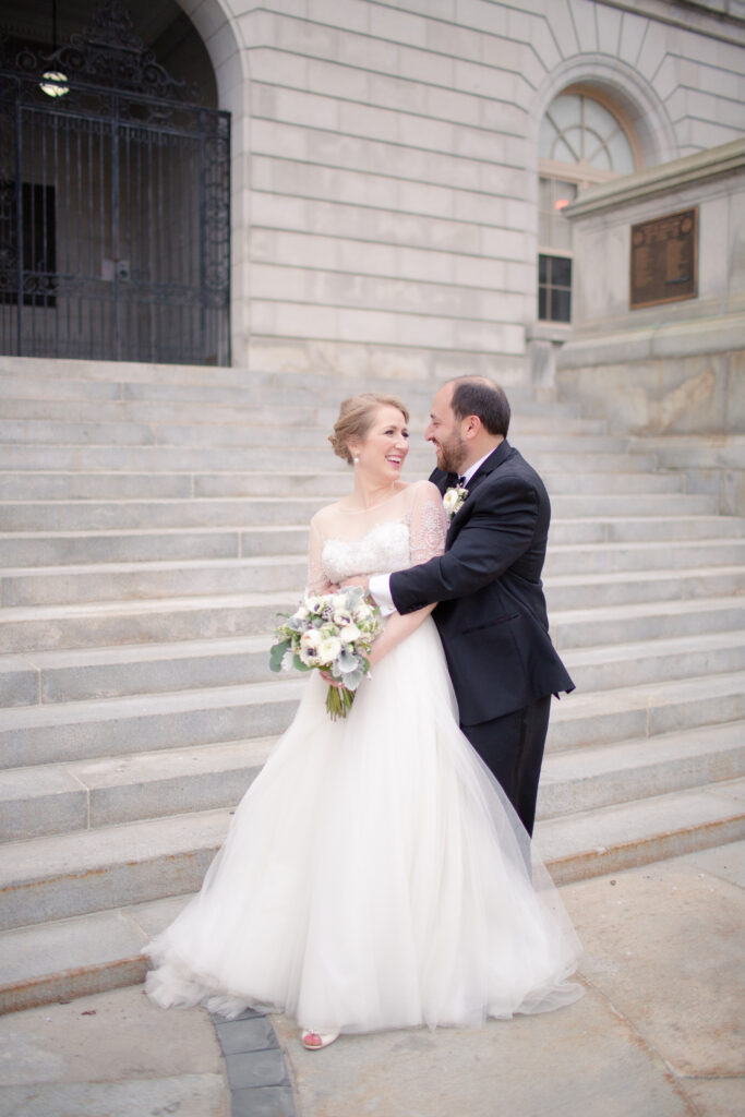 bride and groom hugging 