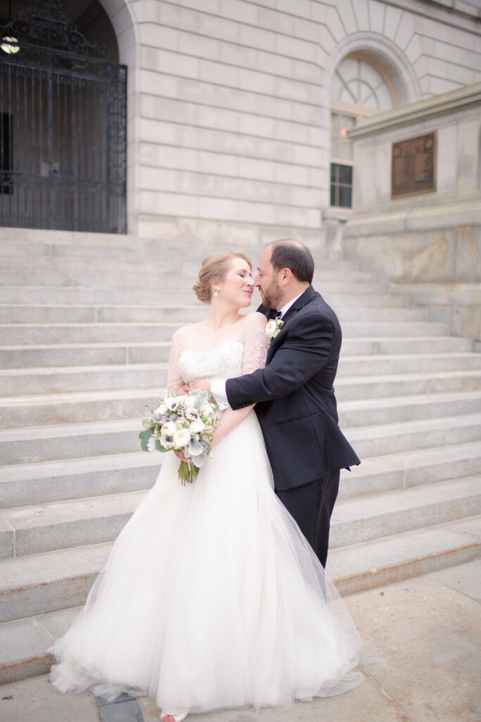 bride and groom kissing in romantic embrace 