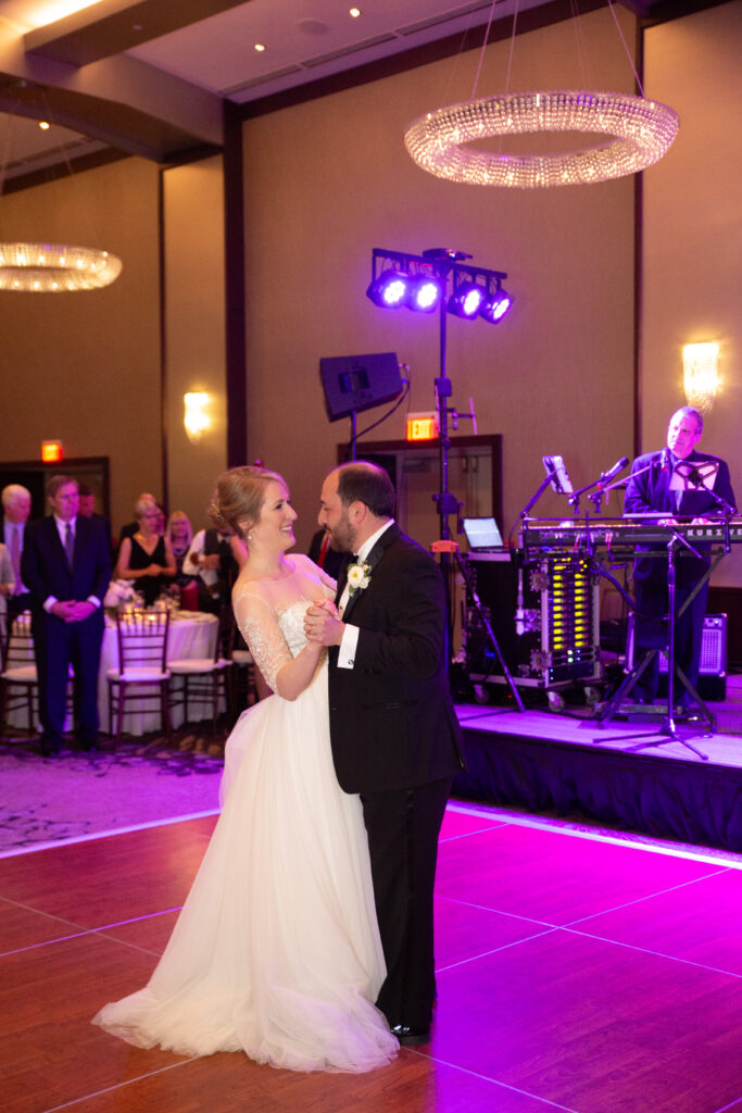 bride and groom first dance in ballroom 