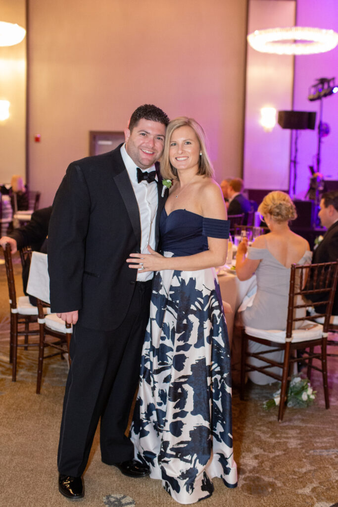 wedding guest couple looking at camera 