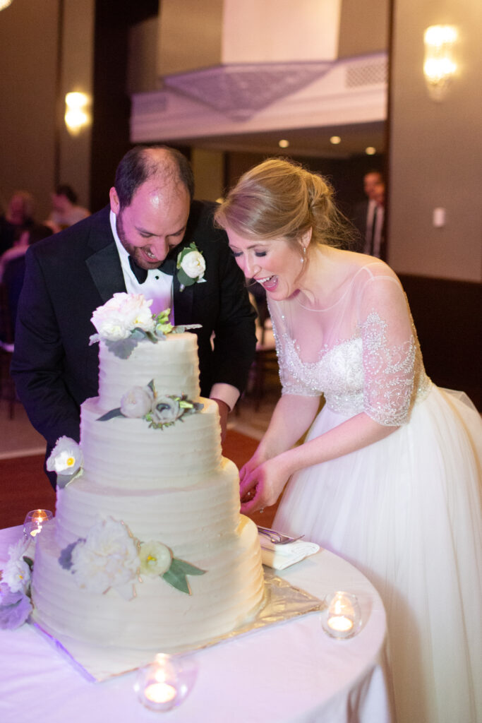 bride and groom cutting cake