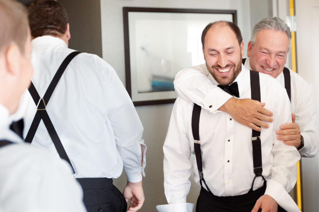 dad and groom hugging