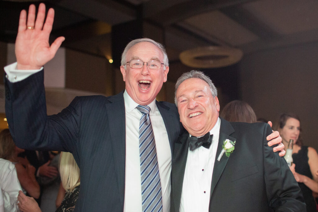 dad and friend laughing at camera 