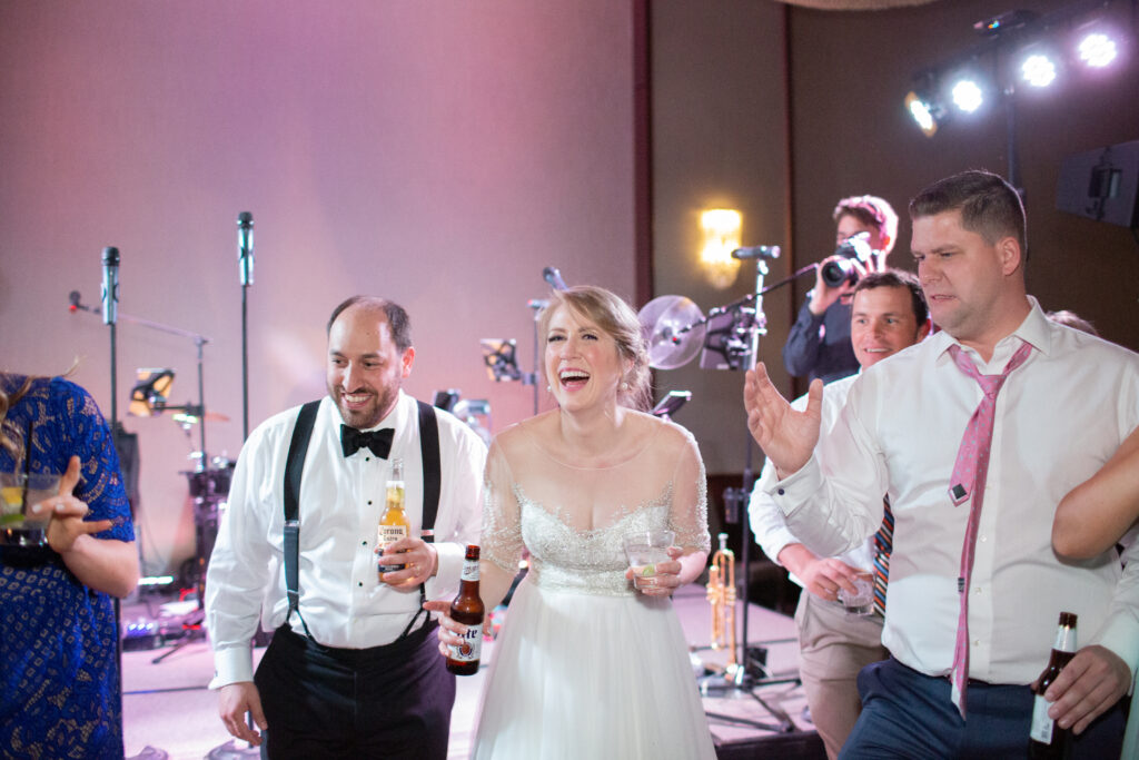 bride and groom dancing with friends