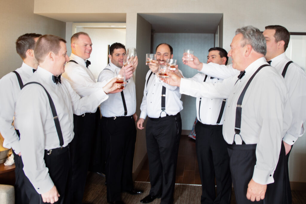 groomsmen cheers with whisky 