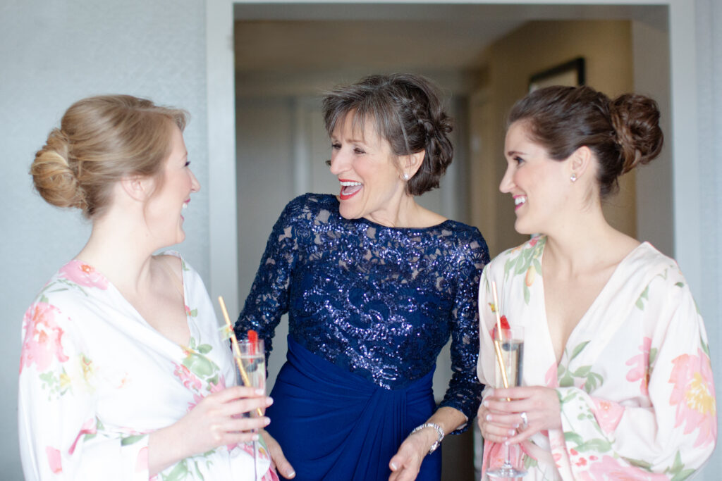 sisters having a moment with their mom while getting ready for the wedding 